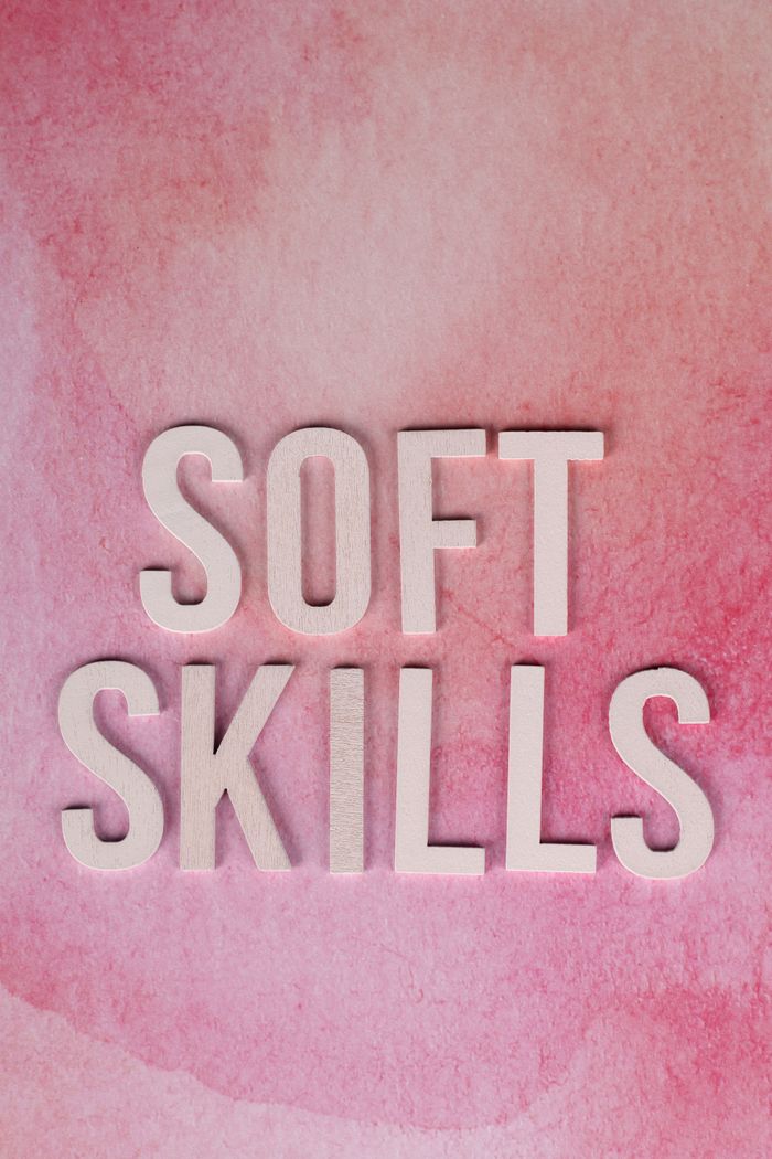 The Art of Drawing Readers In: Your attractive post title goes here Conceptual image of soft skills typography on a pink watercolor background.
