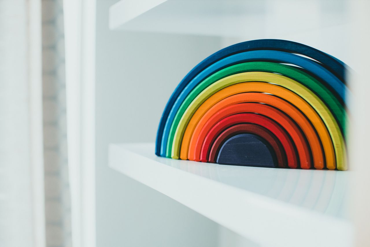 Crafting Captivating Headlines: Your awesome post title goes here Colorful wooden rainbow decoration on a white shelf, perfect for modern home decor.